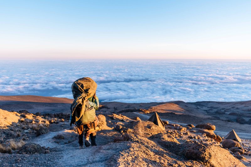 Porter heading down from Kilimanjaro summit passing Barafu camp